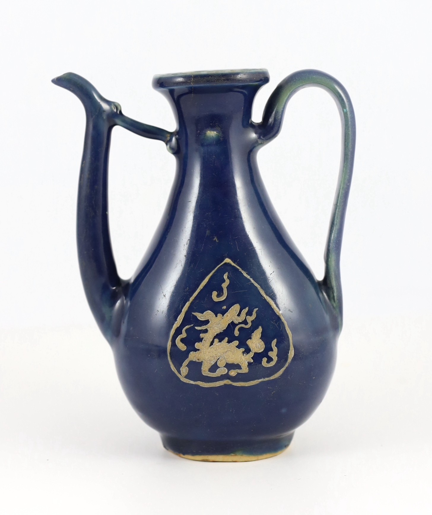 A Chinese late Ming blue glazed and slip decorated ‘qilin’ ewer, for the Islamic market, 19.5cm high, handle and tip of spout restored, wear